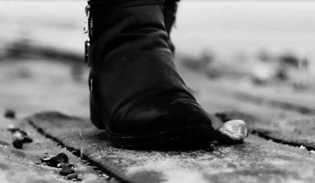 The photo represents a boot walking on a path meant to represent a way through a storm